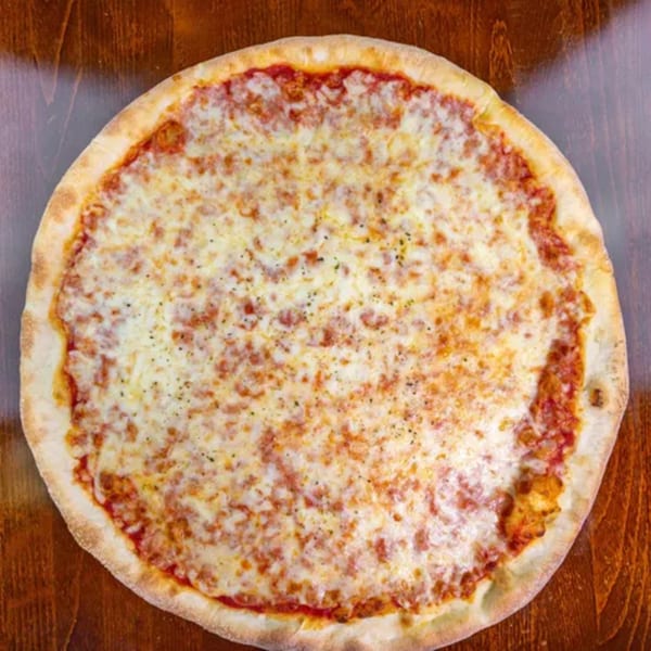 A whole Zio's Pizzeria cheese pizza with a golden crust sits on a wooden table.